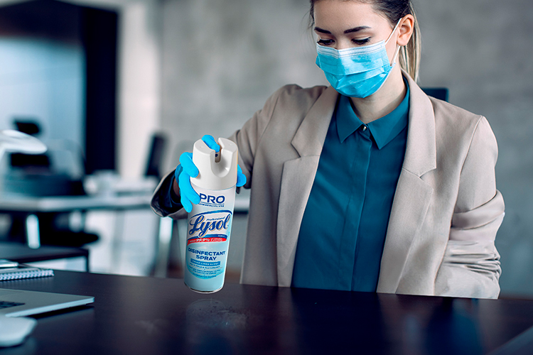 Woman Spraying Lysol Disinfectant Spray